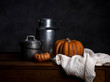 © Westend61 - Pumpkin, tin cans and cloth on wood