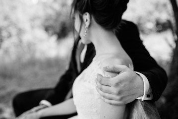 the bride and groom tenderly hold hands between them love and relationships