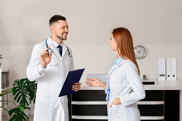 Canvas Print - Male and female doctors in clinic