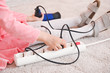 © Pixel-Shot - Little girl playing with electric extension cord and blow dryer at home