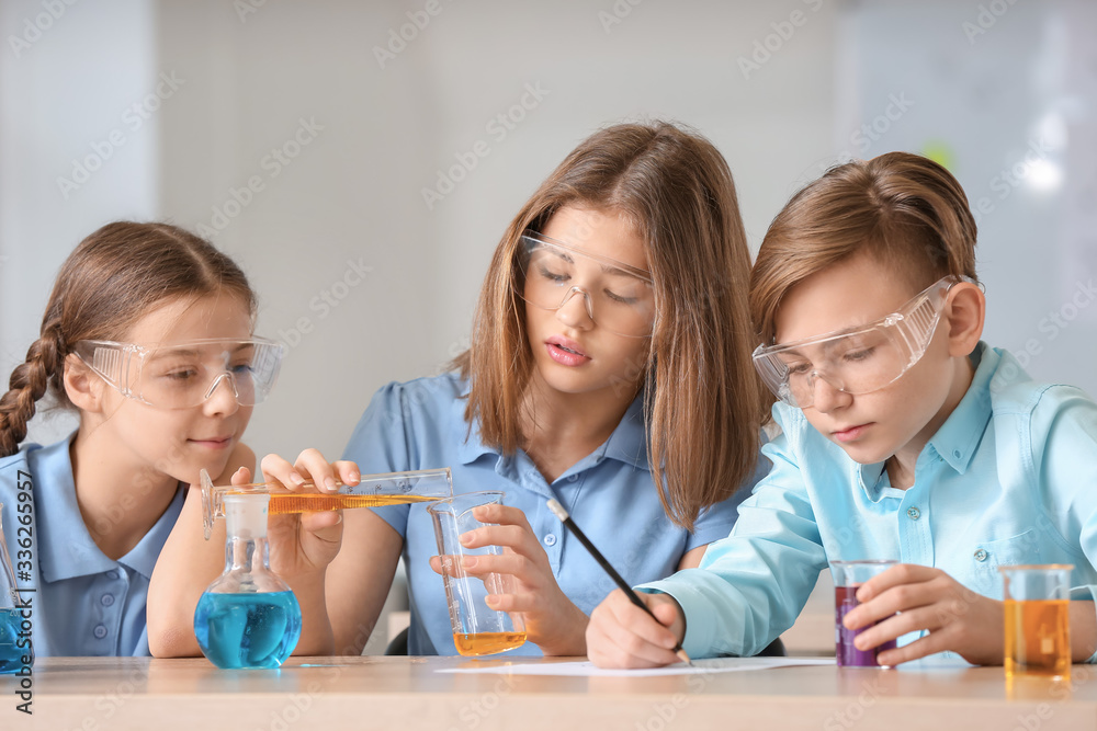 Pupils at chemistry lesson in classroom