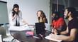 © BullRun - Group of young colleagues preparing for presentation of project