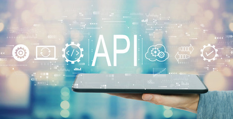 API - application programming interface concept with man holding a tablet computer