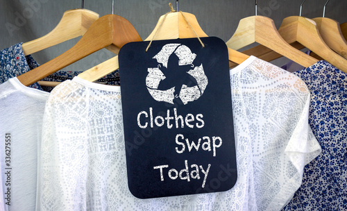 Clothes Swap and recycle clothes icon on chalk board with hanging shirts to swap, sustainable fashion and zero waste, recycle clothes and textiles to reduce waste