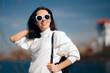 © nicoletaionescu - Fashionable Female Tourist Wearing Sunglasses