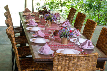 Poster - Served table and rattan chairs in an empty restaurant terrace. Tanzania, Africa