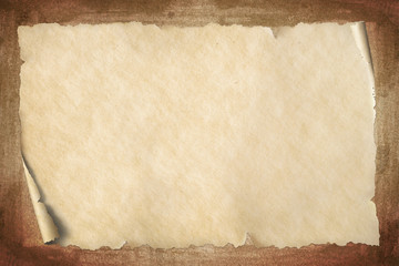 Old vintage beige paper with corner roll up on grungy brown textured background