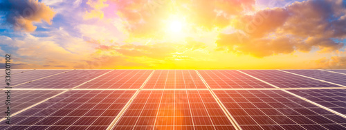 Fotomural Photovoltaic solar panels on sunset sky background,green clean energy concept