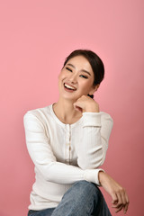 Wall Mural - Asian woman laughing and enjoy on pink background, Portrait of happy smiling middle age woman in casual clothes looking at the camera.