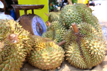 Stack of fresh Durian with scales for sale