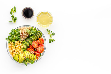 Wall Mural - Vegan bowl. Avocado, quinoa, tomato, spinach and chickpeas vegetables salad on white table top-down copy space