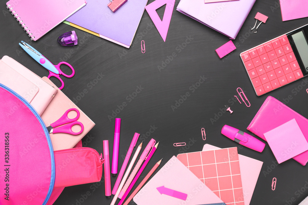 Frame made of school supplies on dark background