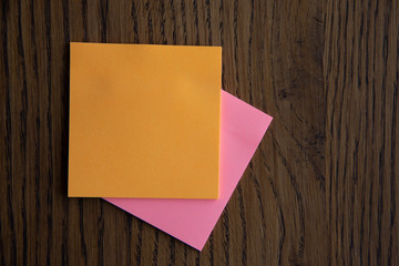 Colorful sticky notes on wooden background image.