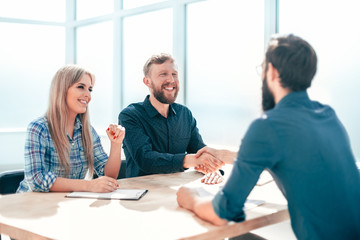 Wall Mural - business people shaking hands at a meeting in the office.