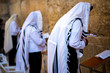 Orthodox Jews praying at the Western Wall, wearing the tallit prayer shawl