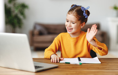 Wall Mural - Girl greeting teacher during online lesson.