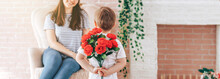 Boy Holding A Bouquet Of Flowers Behind His Back, The Son Gives His Mother Flowers, What To Present To His Mother For His Birthday, March 8, Mother's Day