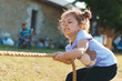 girl pulling rope with force