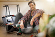 © goodluz - Young guy at home sitting on floor after repairing stuffs