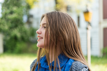 Wall Mural - Portrait of a beautiful teenage girl in park. Close up photo.