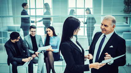 Wall Mural - boss and the assistant discuss a business document.