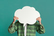 © Prostock-studio - Millennial guy covering his face with speech bubble on turquoise background, space for design