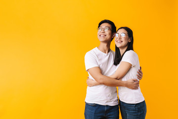 Sticker - Image of cheerful multinational man and woman hugging and looking upward