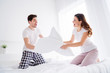 © deagreez - Photo of crazy funny lady cheerful handsome guy married couple in love playing pillow fight sheets bed enjoy weekend saturday morning good excited mood wear pajama room indoors