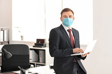 Wall Mural - Male lawyer in protective mask working in office