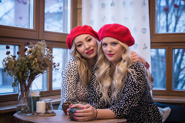 Girlfriens. Two beautiful fashionable women in retro style ..