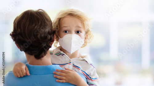 Father and child with face mask and hand sanitizer