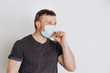 © Елена Лавринович - Protection against contagious disease, coronavirus. The man of European appearance wearing hygienic mask to prevent infection, airborne respiratory illness such as flu, 2019-nCoV, on white background.