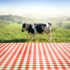 Wall Mural - Table background of free space and cow with natural landscape 
