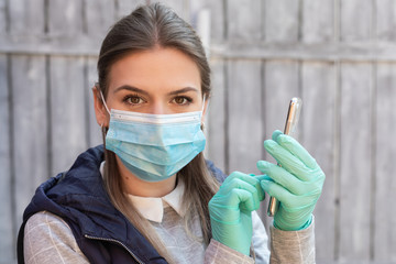 Wall Mural - Woman with mask and gloves having a call