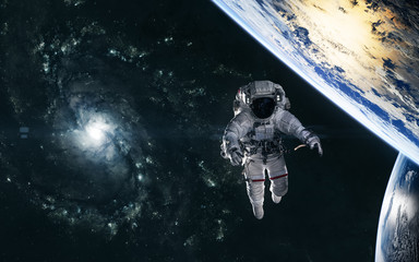 Wall Mural - astronaut, planets on background of spiral galaxy somewhere in deep space. science fiction. elements