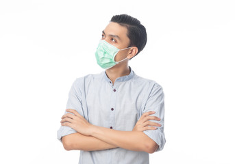 Young Asian Businessman wearing hygienic mask and looking up, Prevent infection, 2019-nCoV or coronavirus. Airborne respiratory illness such as pm 2.5 fighting and flu isolated on white background.