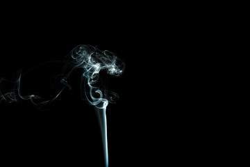 puffs of white smoke with a black background