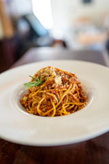 Spaghetti bolognese served on a white plate