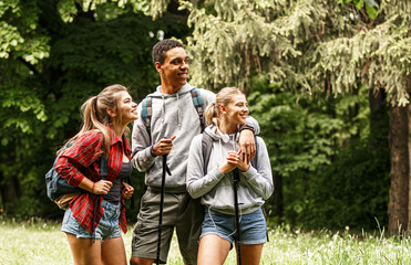 Wall Mural - portrait of young hikers in nature.they look around and joying in nature.