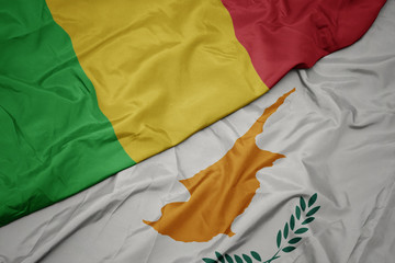 waving colorful flag of cyprus and national flag of mali.