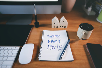 Work form home text on workplace table with computer.