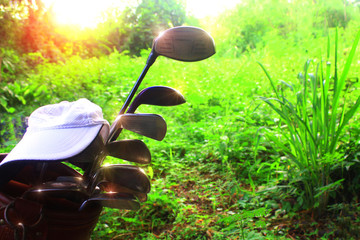 Many golf club equipment on a natural background The golf stadium has sunshine.