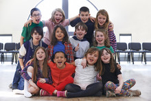 Portrait Of Group Of Children Enjoying Drama Workshop Together
