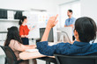 © ztony1971 - Selective focus of office worker raising a hand to give comment, suggest new idea, strategy, brainstorming and sharing idea at the office meeting, teamwork, office worker lifestyle, startup business.