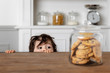 © Lisa Tichané - Toddler looking at cookie jar on kitchen table