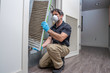 © spatesphoto - HVAC Worker Removing Air Filter