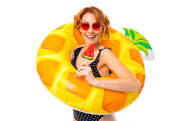 Wall Mural - sexy girl in a swimsuit in a swimming circle in the form of pineapple on vacation on a white background