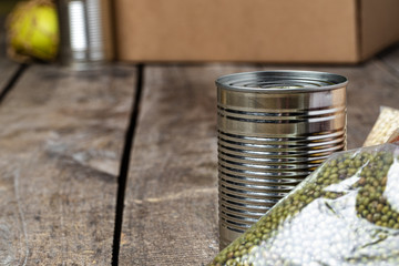 Poster - Donations food with canned food on the table background. Donate concept. Close up.