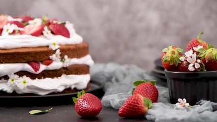 Canvas Print - Strawberry cake, strawberry sponge cake with fresh strawberries and sour cream on a kitchen countertop.