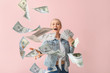 © Pixel-Shot - Beautiful young woman with flying money on color background
